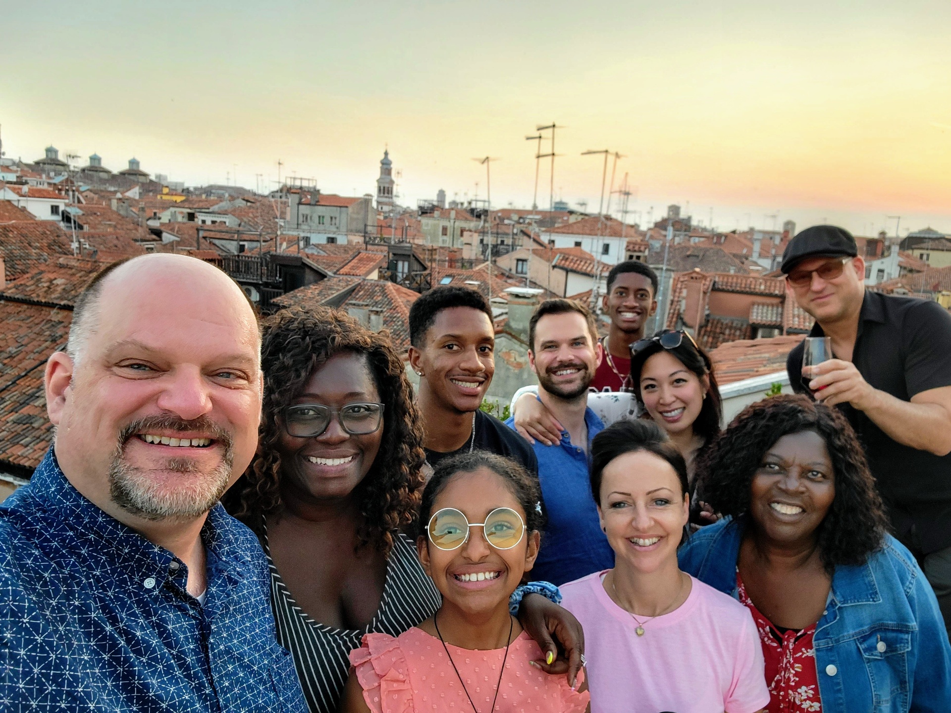 Group photo on Venice rooftop at sunset