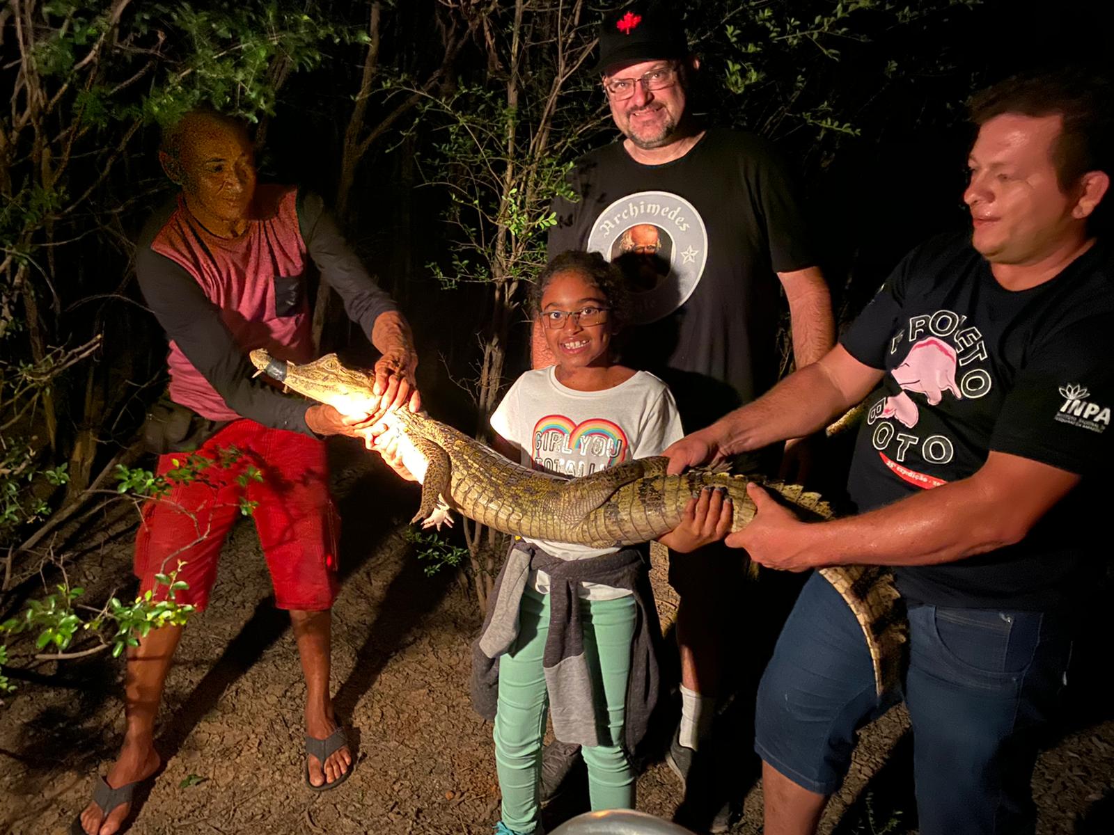 Holding a caiman on a night adventure