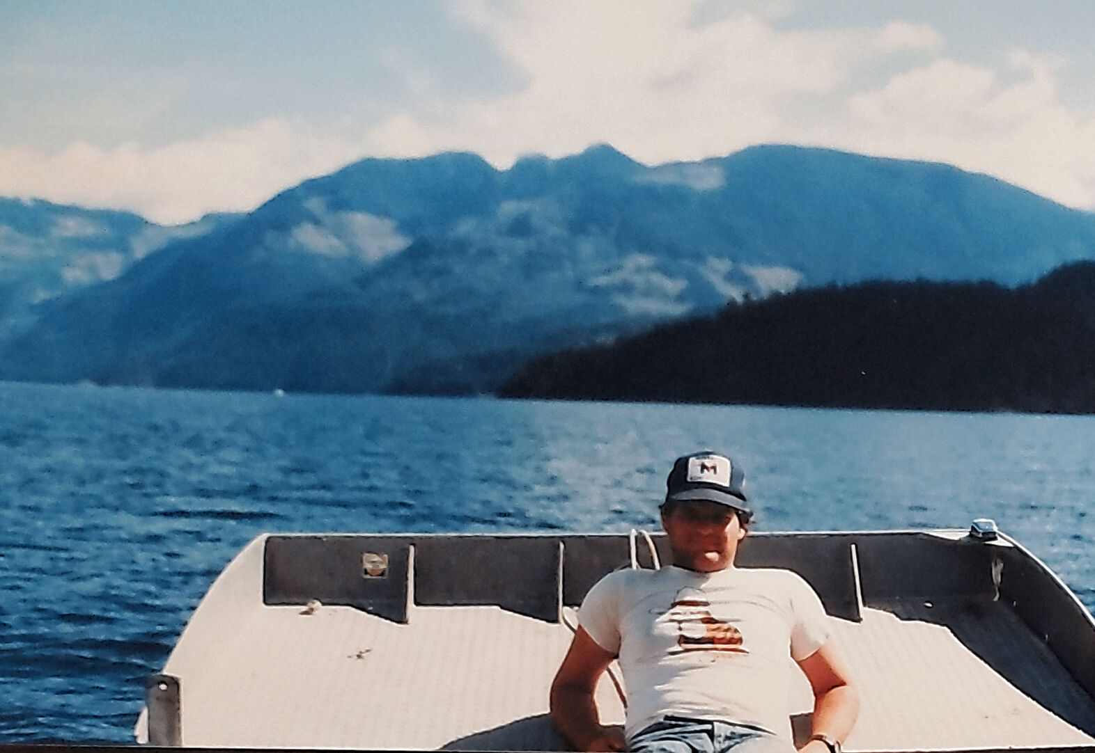 Young Tony relaxing on a boat on a mountain lake