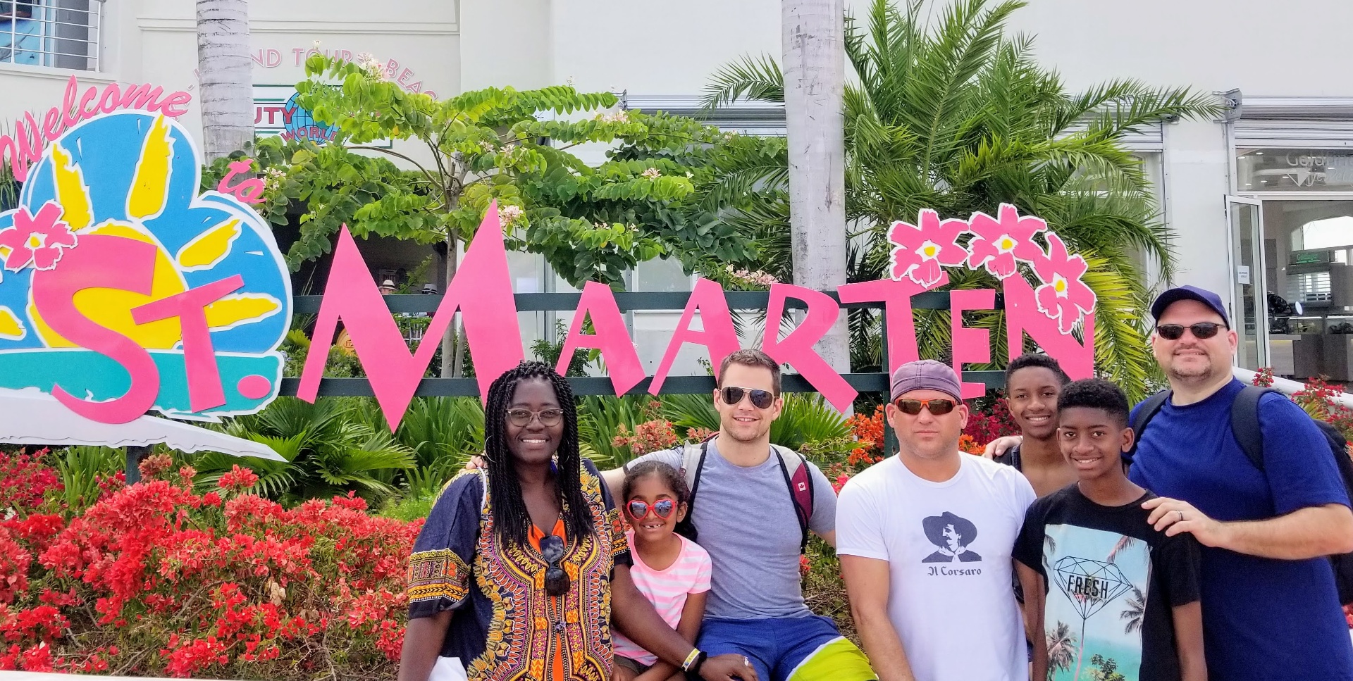 Family group photo at Welcome to St. Maarten sign